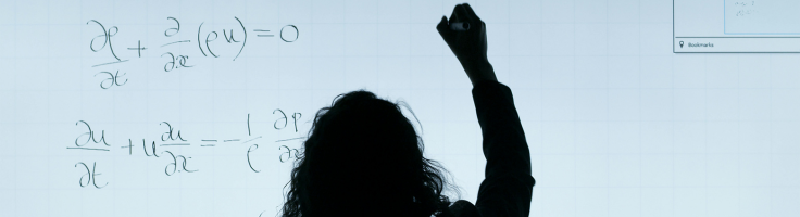 Teacher writing on digital whiteboard