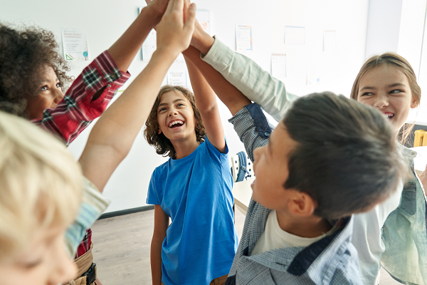 school pupils joining hands