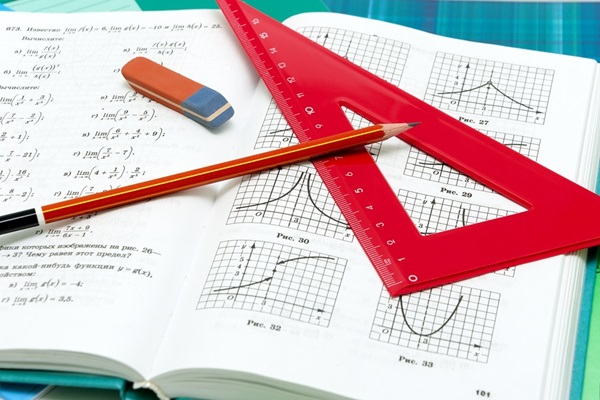 School supplies and textbooks on mathematics close up