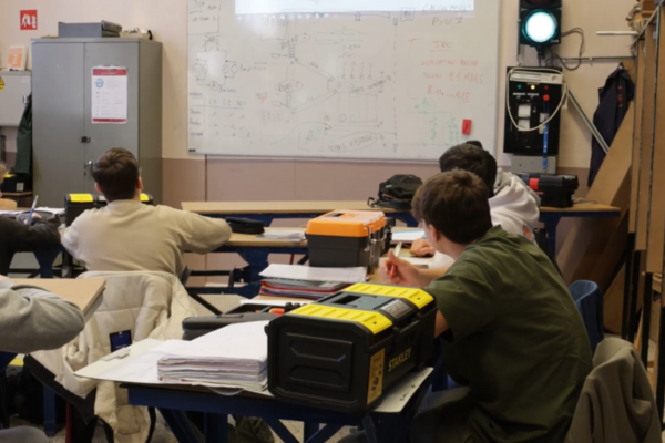 Students in classroom looking at a whiteboard 