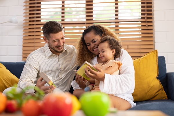 Parents with very young child looking at a book