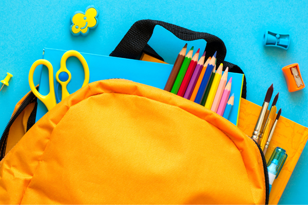 Illustration of a yellow backpack with school supplies