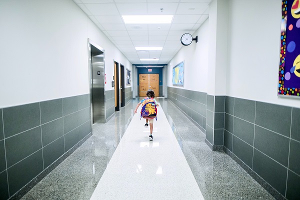 Child running down school hall