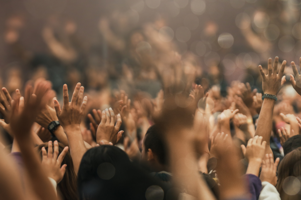 crowd raising hands