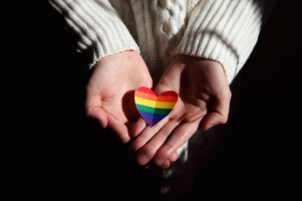 hands holding rainbow heart