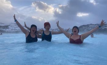 Image of teachers emerging with confidence from the thermal water in the Blue Lagoon.  Snow-covered lava fields in the background.